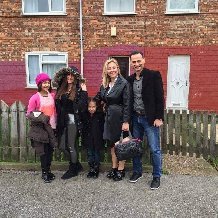 Esther and her family outside their new home in Hull.
